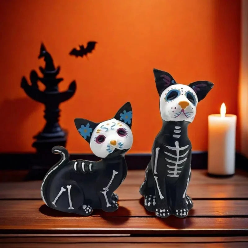 A black and white resin figurine set of a dog and cat in Day of the Dead style against an orange wall.