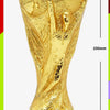 Gold trophy figurine of the FIFA World Cup, featuring a green base.
