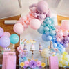 A colorful arrangement of pastel latex balloons in pink, purple, and blue for parties and celebrations.