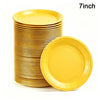 A stack of yellow 7-inch disposable paper plates, with one plate lying next to the stack.