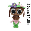 A brown plush toy with large black eyes, green legs, and purple and pink floral accents.