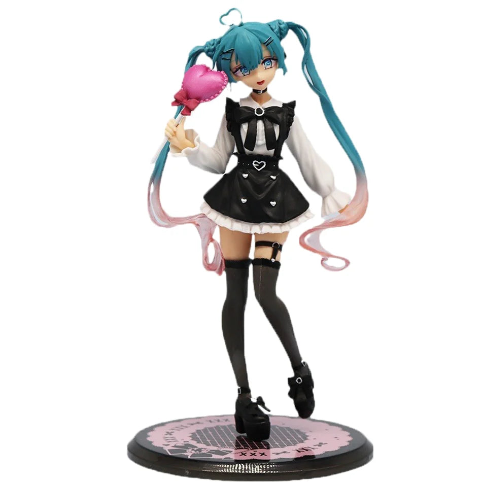 A PVC collectible figurine of Hatsune Miku in a black and white outfit with pink hair and a pink accessory.