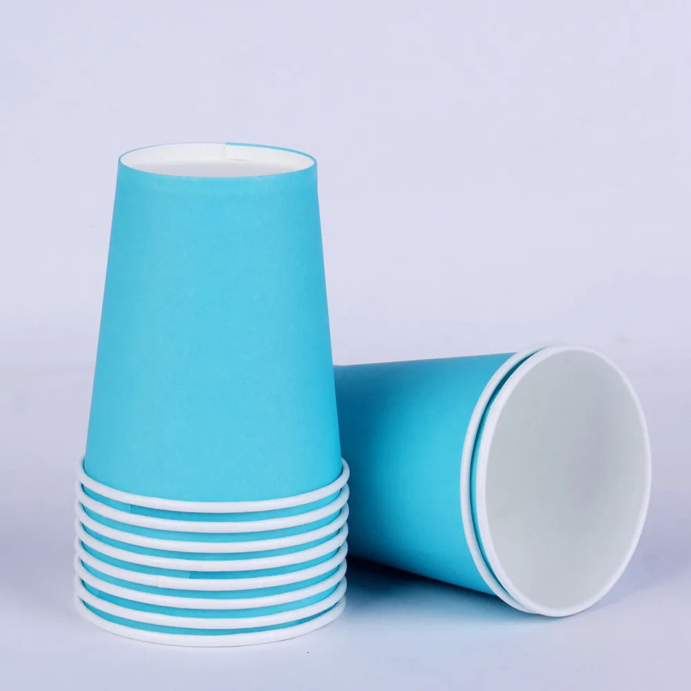 A stack of light blue disposable cups with white rims and a single cup lying beside them.