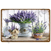A vintage metal tin sign featuring a bouquet of purple lavender flowers in a white vase.