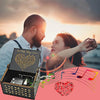 A woman and man embracing against a sunset background with a music box in the foreground.