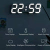 ساعة حائط رقمية تعرض 22:59 مع أيقونات لعرض الوقت، ودرجة الحرارة، ووظيفة المنبه، وعرض الدورة، والصور