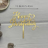 Gold acrylic birthday sign with a heart design on a wooden surface.