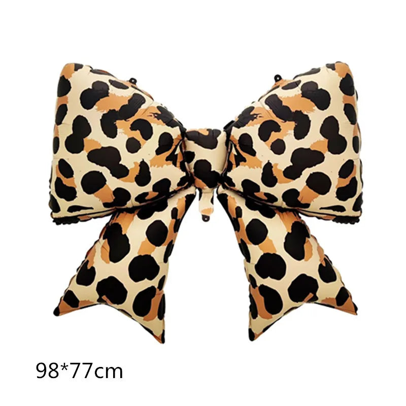 A bow-shaped balloon featuring a leopard print pattern in shades of black, brown, and tan.