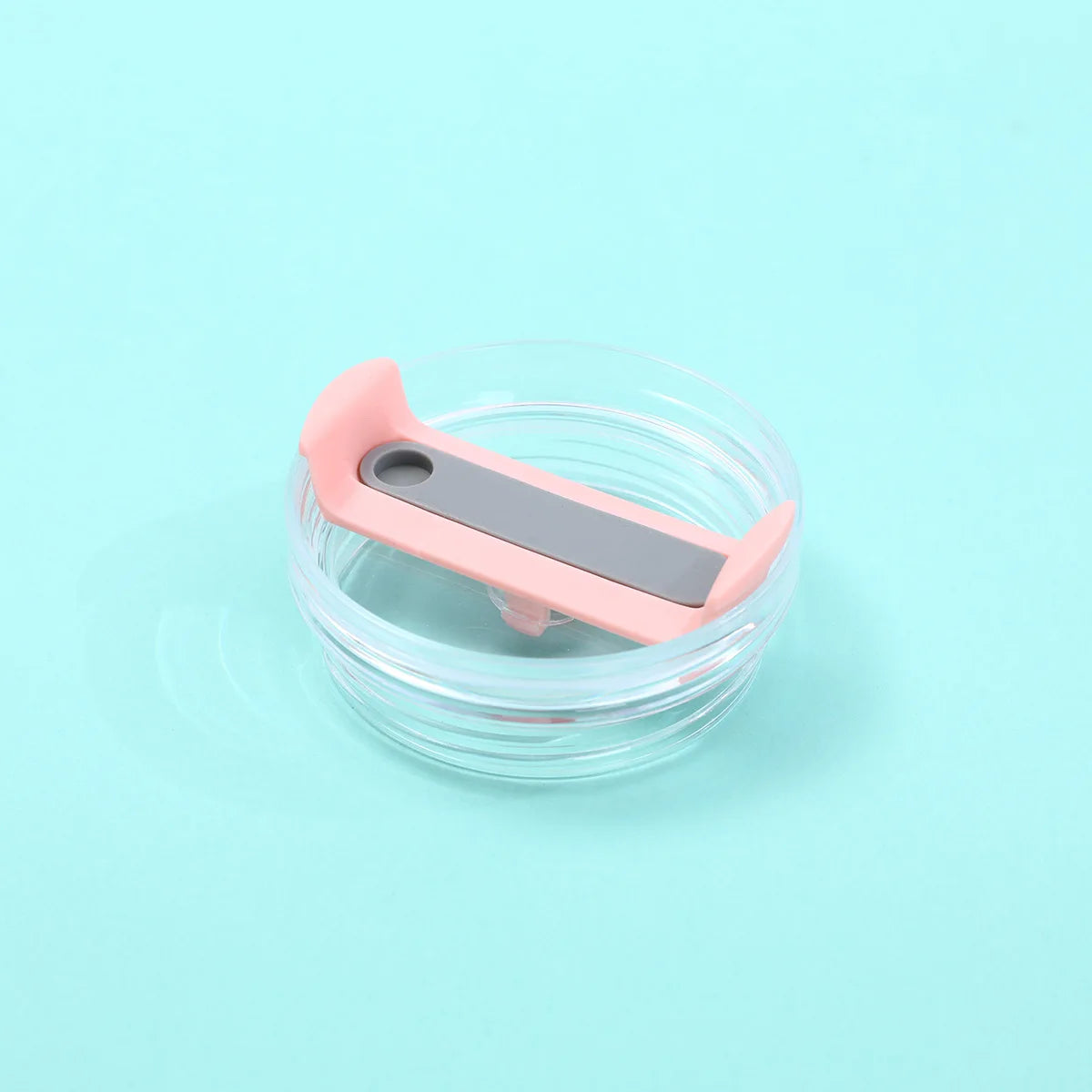 A pink and gray replacement lid for a tumbler, designed as a spill-resistant cover.