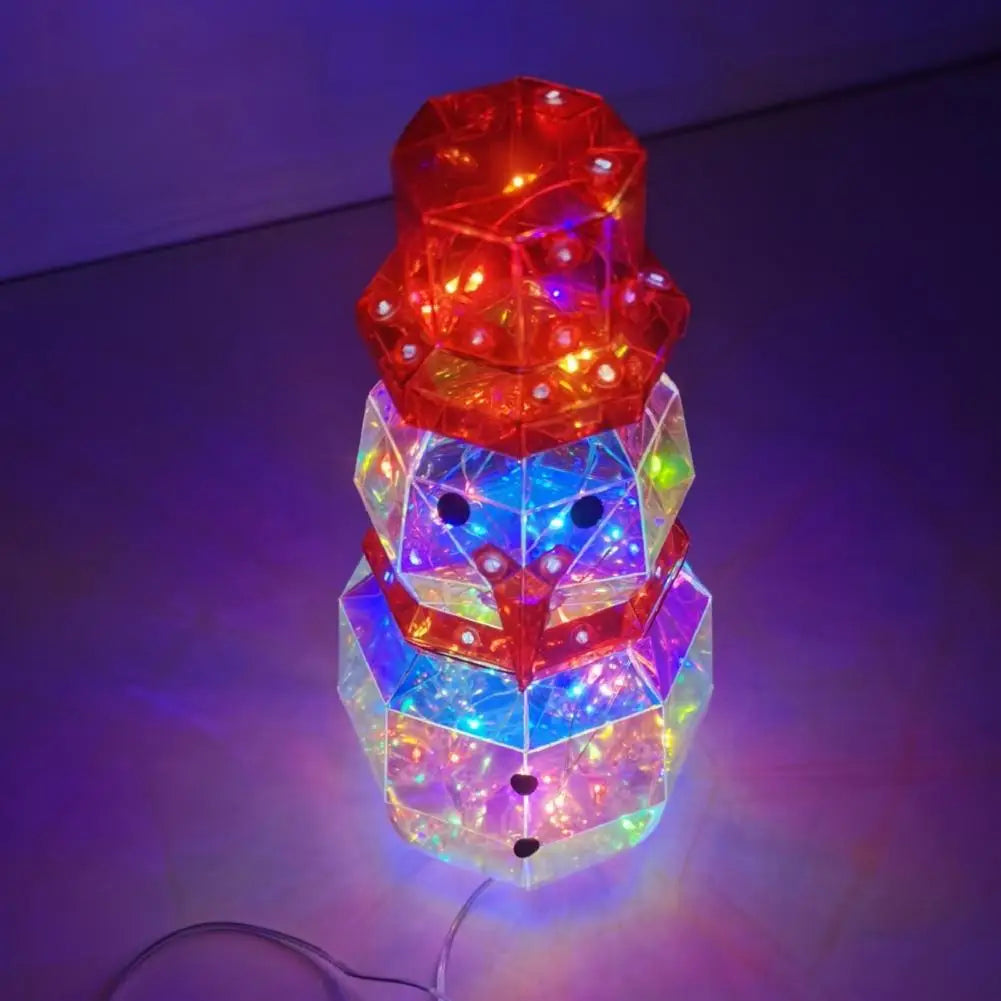 A colorful prismatic LED snowman decoration with glowing lights on a wire.
