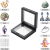 A display frame featuring various jewelry items including a brooch, seashell, coin, stone, earrings, rings, and fake nails.