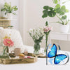 A blue butterfly heart acrylic table decor featuring a blue butterfly design and the words you are loved