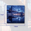 A magnet featuring a nighttime cityscape with the Brooklyn Bridge and Manhattan skyline reflected in water.