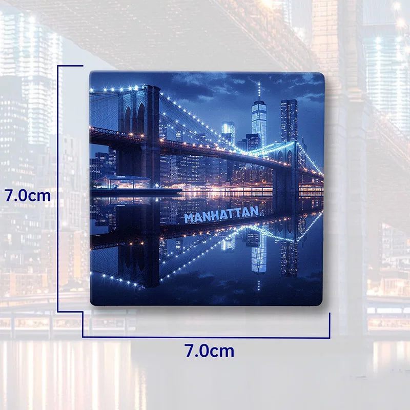 A magnet featuring a nighttime cityscape with the Brooklyn Bridge and Manhattan skyline reflected in water.