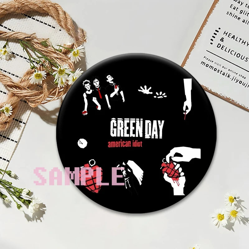 A set of black button pins featuring punk band imagery and text on a white background