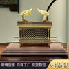 Gold metal statue of the Ark of the Covenant resting on a wooden base