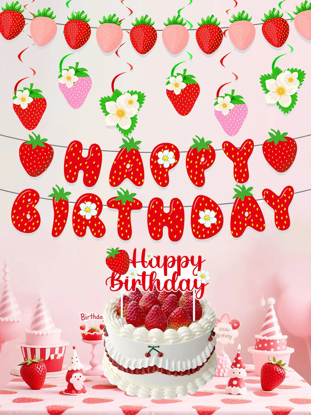A strawberry birthday party decoration set featuring a banner, cake toppers, and a strawberry cake.