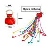 A set of 30 red and brown paper ribbons for party decor, shown next to a display of the finished streamers.