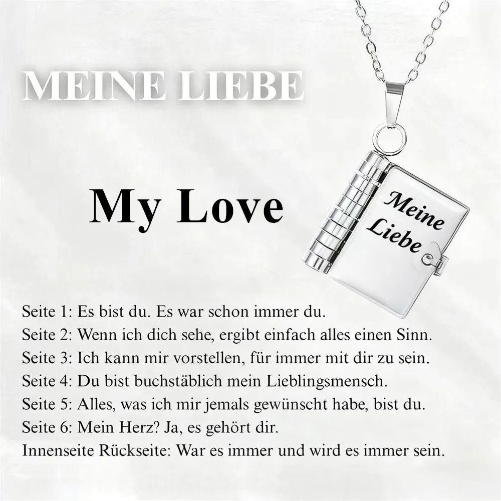 Silver pendant necklace featuring an openable book design with German text engraved on the cover