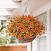 A realistic artificial flower hanging basket filled with vibrant orange and yellow blooms, suspended from the ceiling.