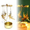 A gold rotating candle holder with metal wings and a base, designed for heat-powered spinning tealights.
