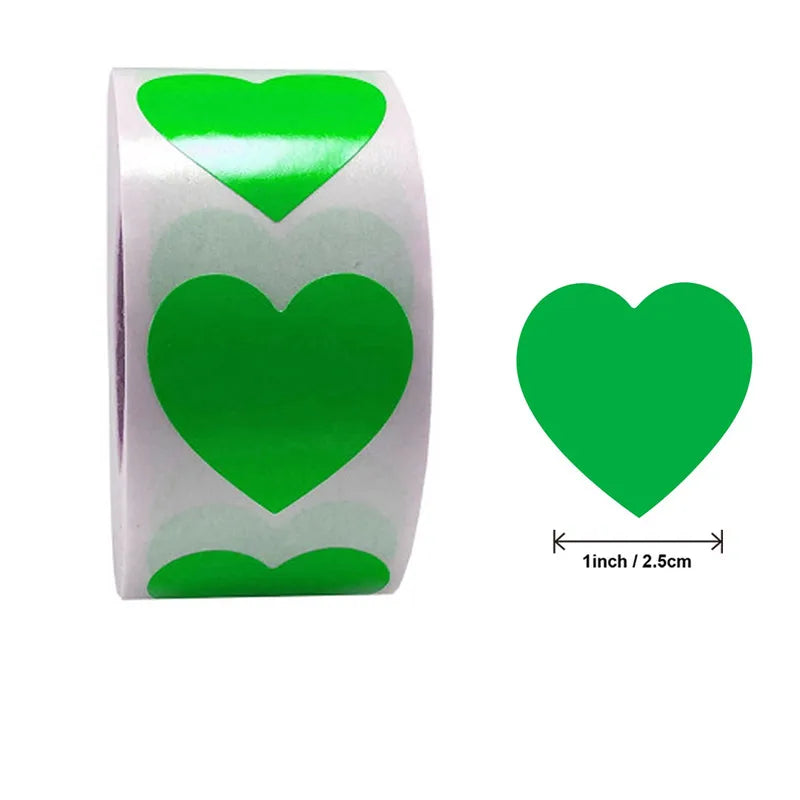 A roll of green heart-shaped seal stickers for crafting and packaging.