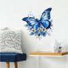 A watercolor blue butterfly decal featuring yellow and blue floral accents on a white wall.