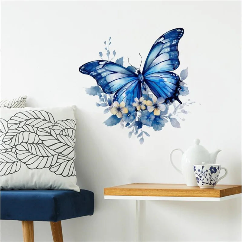 A watercolor blue butterfly decal featuring yellow and blue floral accents on a white wall.