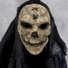 A realistic full-face latex mask resembling a skull with dark fabric draped over it.