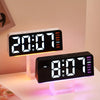 A black LED digital alarm clock with an ambient glow displays the time 20:07 and the day of the week.