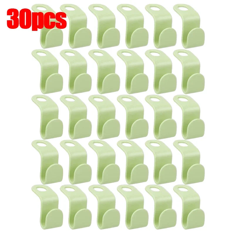 A set of 30 light green space-saving hanger connector hooks.