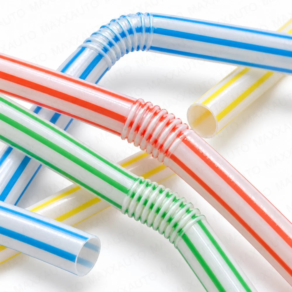A close-up of flexible reusable drinking straws in various striped colors including red, white, blue, green, and yellow.