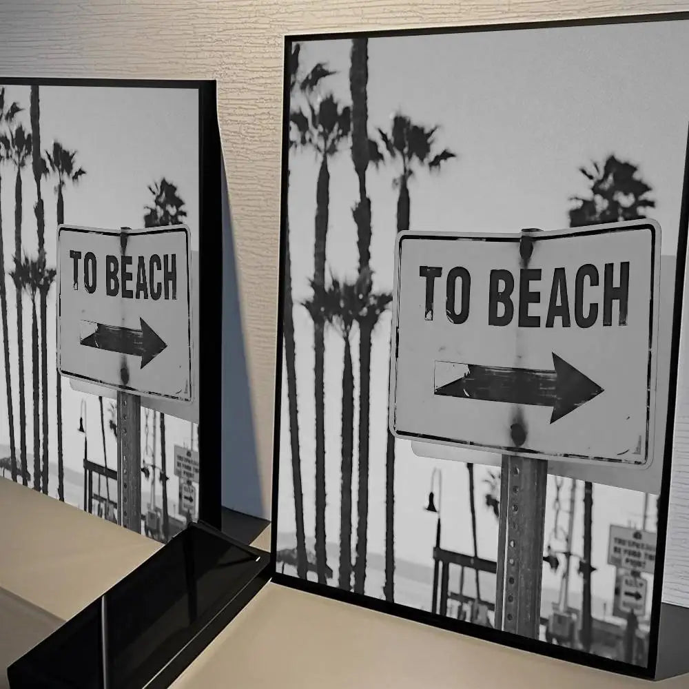Black and white poster featuring a sign that reads To Beach with palm trees in the background