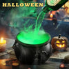 A black witch cauldron is pouring a green liquid into the air, creating fog and mist in a dark Halloween setting.