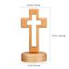 A wooden crucifix wall ornament with a cross mounted on a circular base.