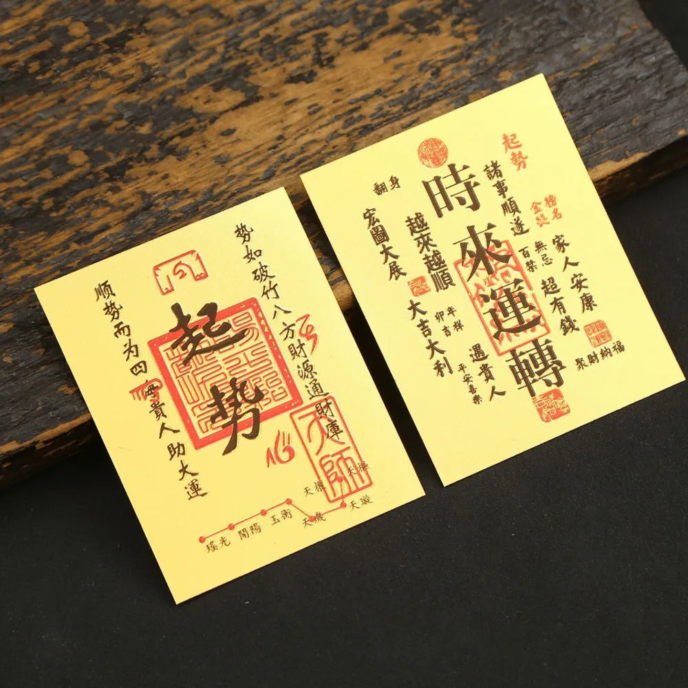 A yellow sticker with red Chinese characters for lucky wealth and prosperity is placed on a dark wooden surface.