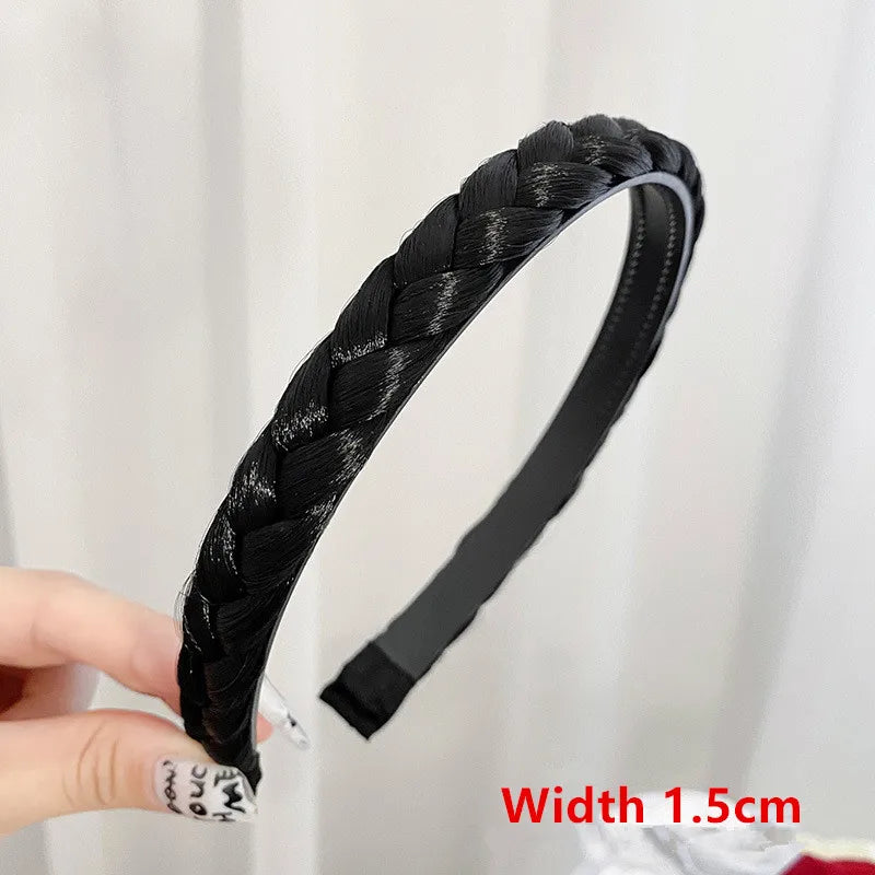 Black braided hair band with a black elastic strap shown on a hand.