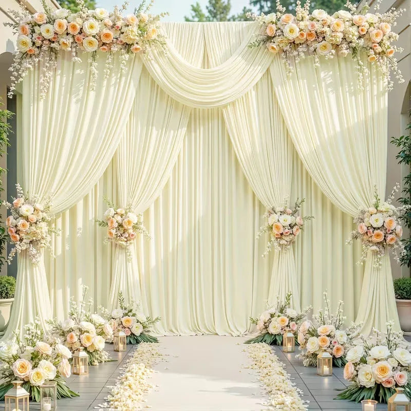 Elegant rectangular backdrop drapes in cream fabric with floral accents and a white aisle.