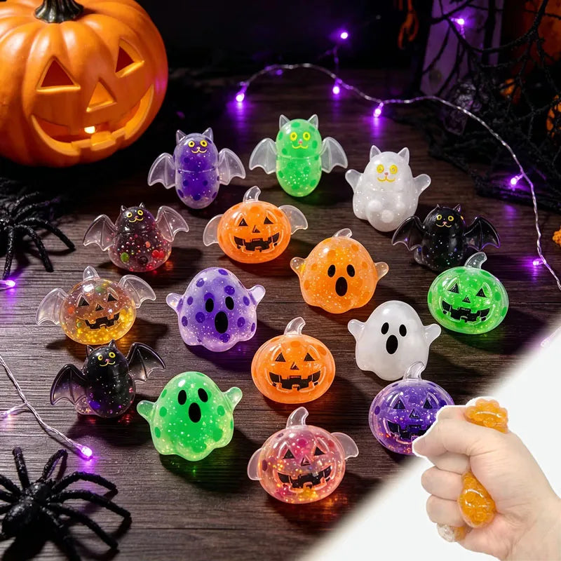 A collection of colorful Halloween sensory squishy beads including pumpkins, bats, and ghosts on a dark surface.