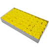 A rectangular box filled with numerous yellow artificial rose heads for wedding and party decor.