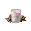 A glass jar of pink scented candle with a white label and loose coffee beans surrounding it.