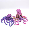 A purple articulated 3D printed octopus figurine with tentacles in various shades of purple and pink.