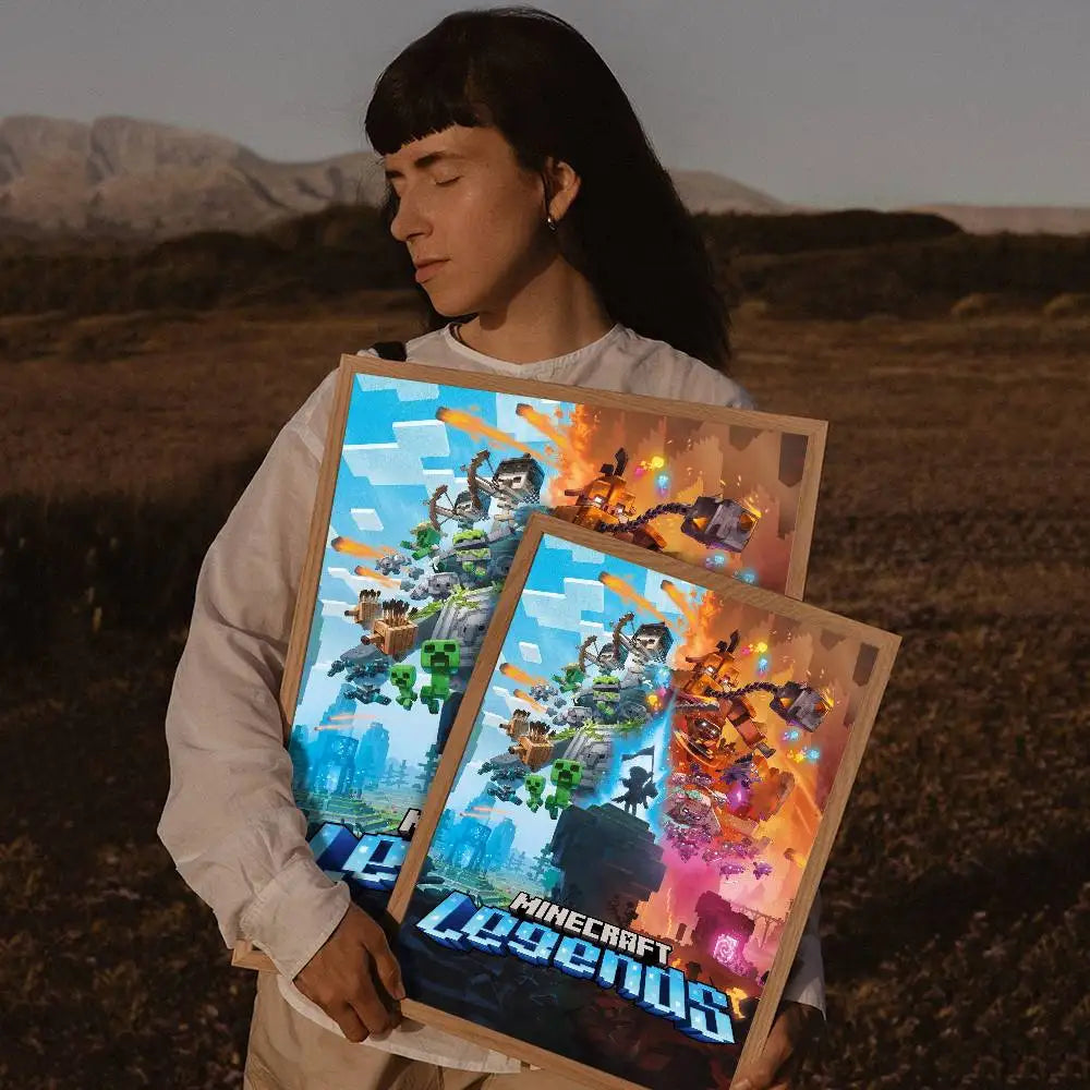 A person holds up a framed piece of digital art featuring dynamic fantasy scenes and the text Minecraft Legends