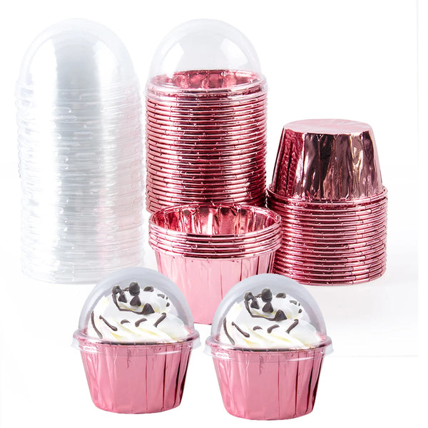 A collection of shiny pink foil cupcake liners and clear plastic cupcake wrappers.