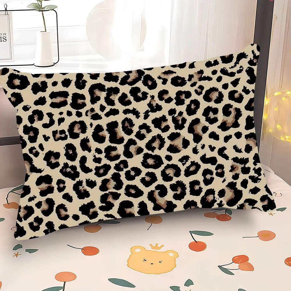 A decorative pillow cover featuring a black and tan leopard print on a white background.