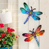 A colorful dragonfly wall art sculpture featuring iridescent blue and green wings mounted on a white wooden panel.