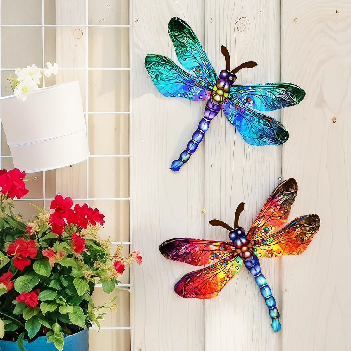 A colorful dragonfly wall art sculpture featuring iridescent blue and green wings mounted on a white wooden panel.