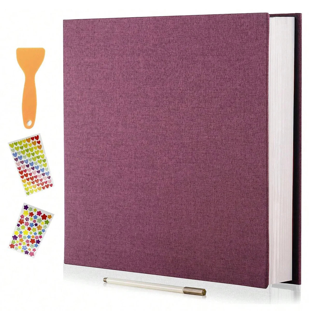 A purple linen scrapbook photo album with a spine visible and an orange glue stick next to it.