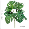 Artificial Monstera plant with silk green leaves shown against a white background.
