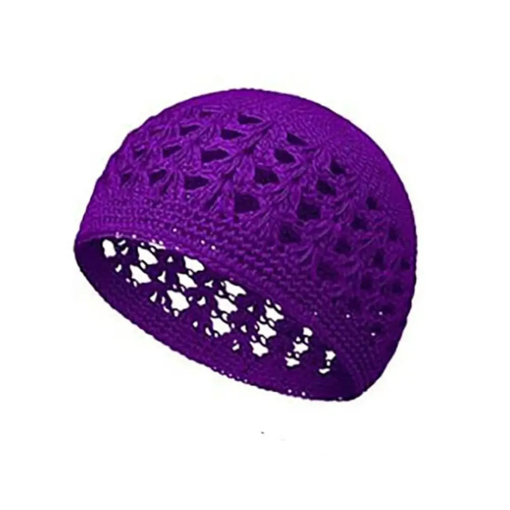 A handmade crochet beanie hat in vibrant purple with an openwork pattern.